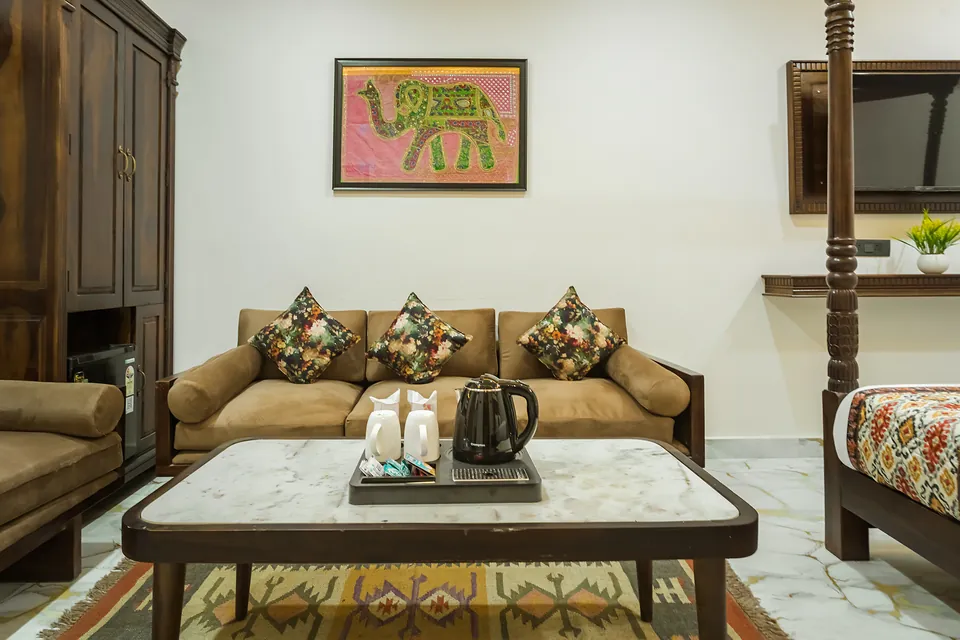 King Suite lounge with sofa, tea tray and elephant artwork