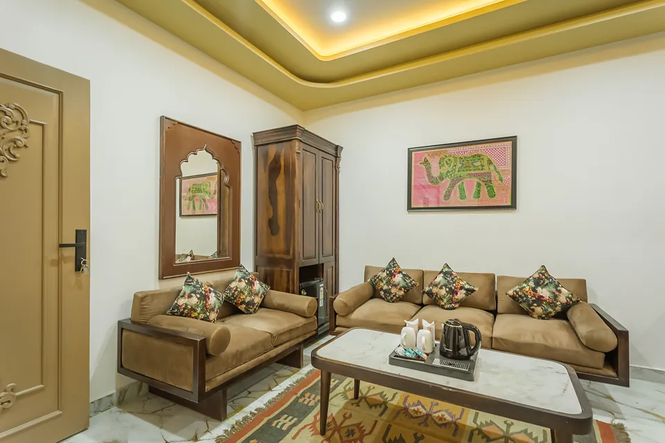 King Suite living area with carved wooden wardrobe
