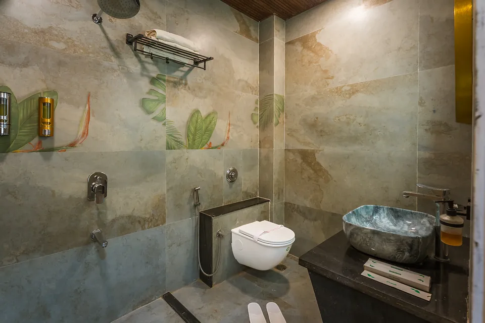 Signature Room bathroom with stone vessel basin and painted wall