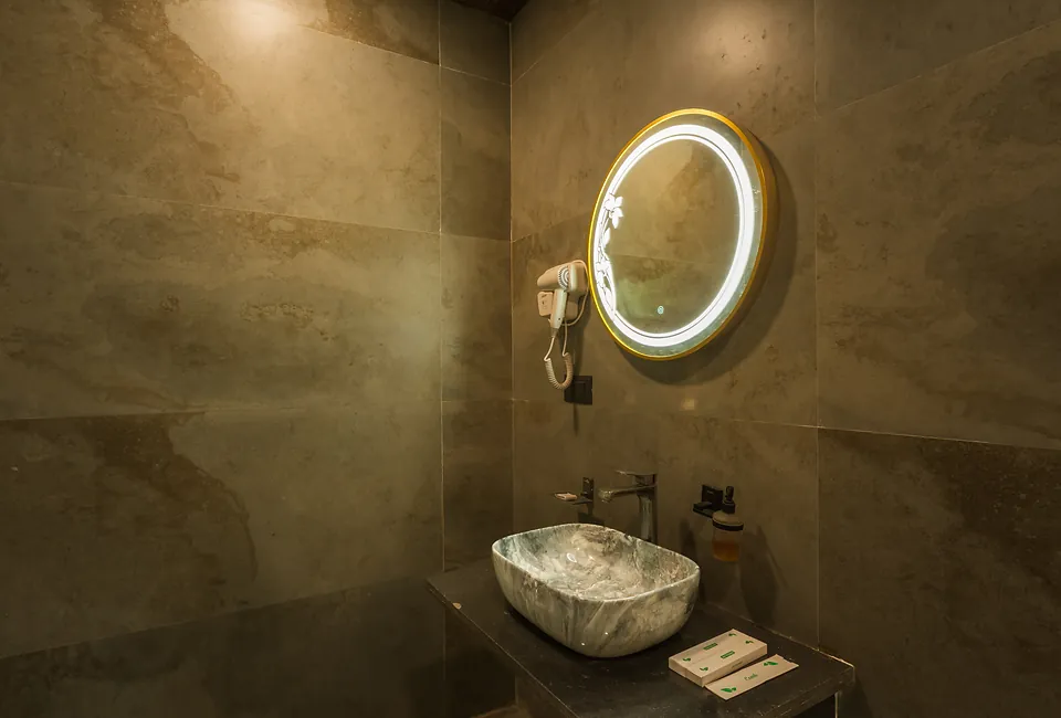 Signature Room bathroom vanity with backlit round mirror