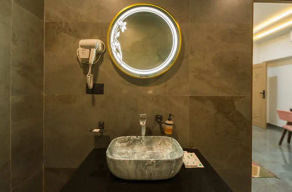 Stone vessel basin and LED mirror in the Signature Room bathroom